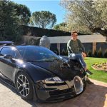 3D9B2CDD00000578-4255766-Ronaldo_poses_with_his_black_Bugatti_Veryon_which_he_bought_for_-a-15_1487931205525